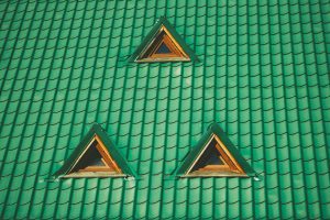green pitched roof with three tirangle windows